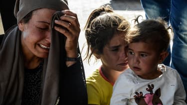 Des proches de victimes des attentats à la voiture piégée commis dans la nuit du 25 juin, à Kobané.