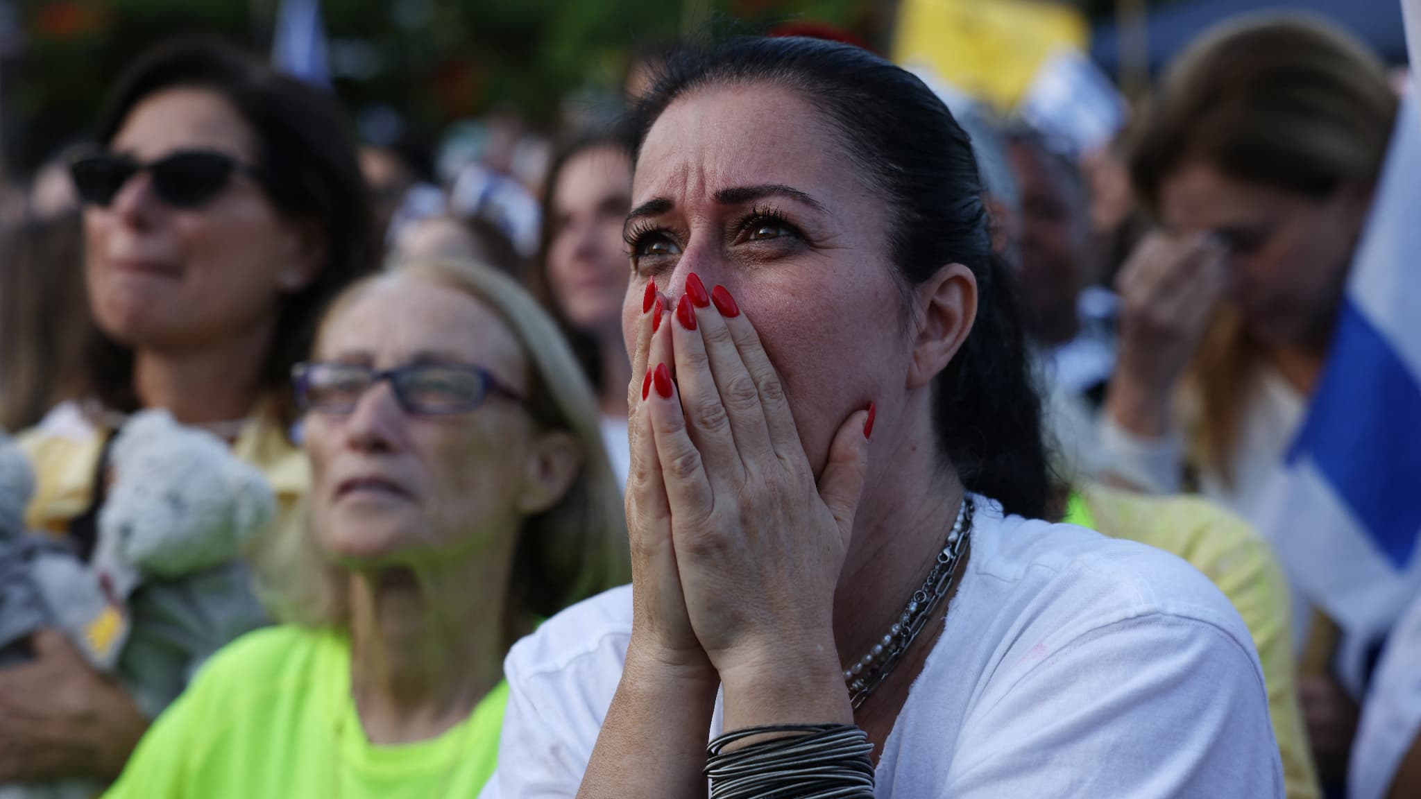 Israelis react as they await the release of Israelis still detained in Gaza, in Hostage Square in Tel Aviv, early in the morning on October 13, 2025.