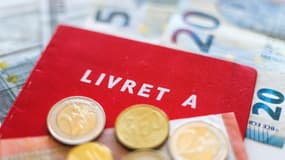 Un livret rouge Livret A posé sur des billets en euros accompagnés de pièces en euros, le 13 janvier 2025 (photo d'illustration).