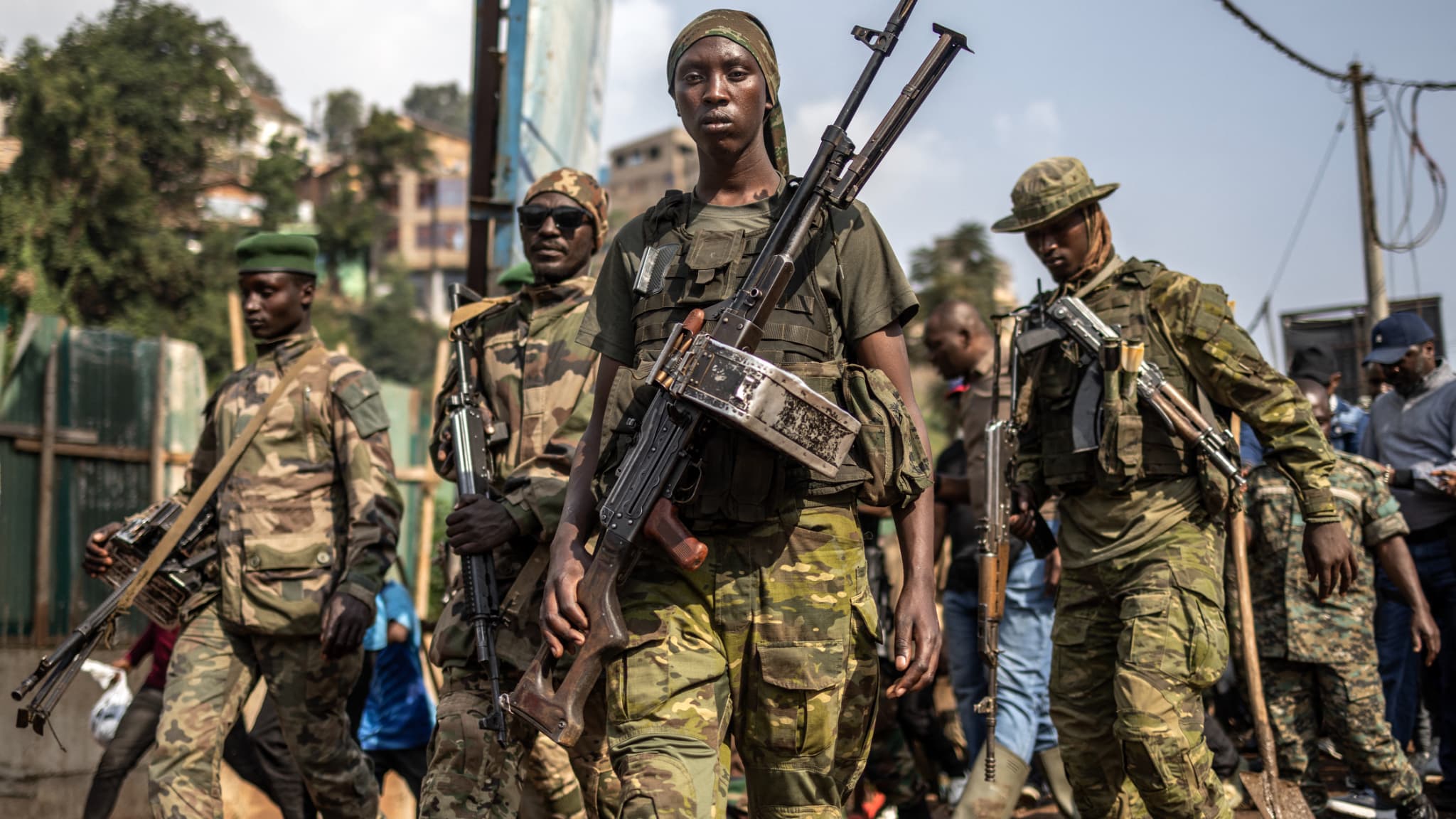 Members of the M23 movement monitor the area while guarding senior members of the group during a special clearing exercise and public meeting conducted after the takeover of the city at Independence Square in Bukavu, DRC, February 20, 2025.