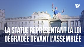 Devant l’Assemblée nationale, la statue représentant la loi  dégradée par l’ONG Attac