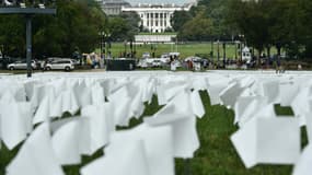 La Maison Blanche est vue au travers d'un champ de drapeaux blancs, sur le Mall à Washinton, symbolisant les morts du Covid-19 aux Etats-Unis, le 16 septembre 2021