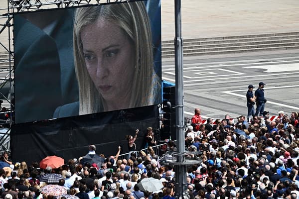 Italian Prime Minister Giorgia Meloni at Silvio Berlusconi's funeral broadcast on a giant screen in front of the Milan Cathedral, on June 14, 2023.