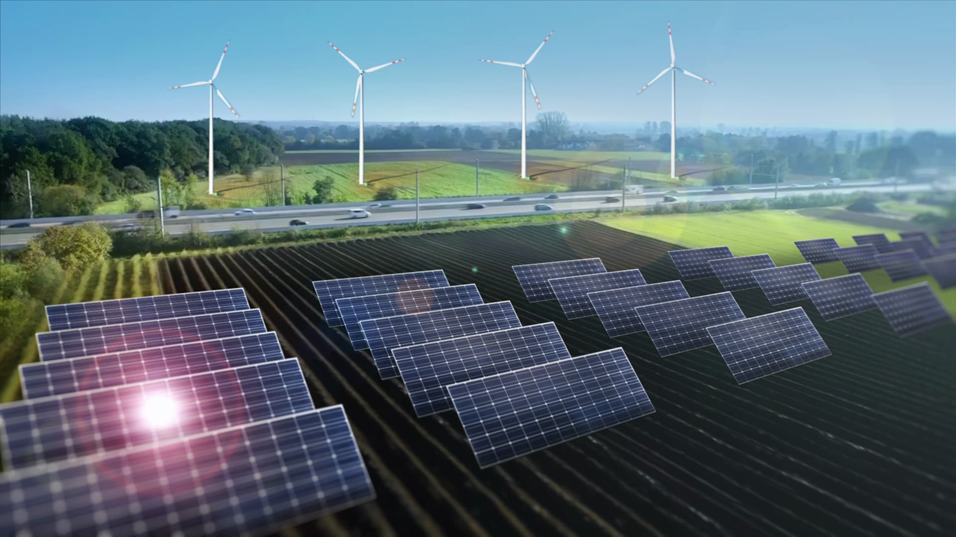 Des éoliennes et des panneaux solaires installés le long d'une autoroute (image réalisée avec trucage).