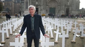 Jacques Jeffredo pose à côté de quelque 600 croix en mémoire des agriculteurs suicidés, le 11 octobre 2015 à Sainte-Anne-d'Auray, dans le Morbihan.