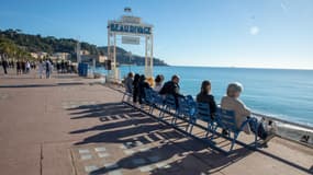 Des personnes profitant du beau temps et du soleil le 18 novembre 2023 sur la promenade des Anglais à Nice (Alpes-Maritimes).