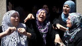 Des Palestiniennes pleurent pendant les funérailles d' un haut commandant du groupe radical Jihad islamique, tué avec 5 membres de sa famille dans la nuit de mardi à mercredi dans des raids aériens israéliens sur Beit Hanoun, au nord de la