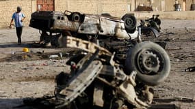 Véhicules détruits après l'explosion d'une voiture piégée, au sud de Bagdad. Au lendemain d'une première vague d'attentats ayant fait une vingtaine de tués en Irak, une nouvelle série d'attaques coordonnées, les plus meurtrières depuis des semaines, a vis