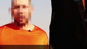 Capture d'écran de la vidéo diffusée mardi sur Internet par l'Etat Islamique. L'homme qui porte un vêtement orange est le journaliste américain Steven Sotloff.