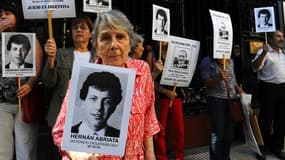 Beatriz Cantarini de Abriata, mère de Hernan Abriata, arrêté en 1976 en Argentine et depuis disparu, brandit un portrait de son fils, avec des proches, devant l'ambassade de France, à Buenos Aires.
