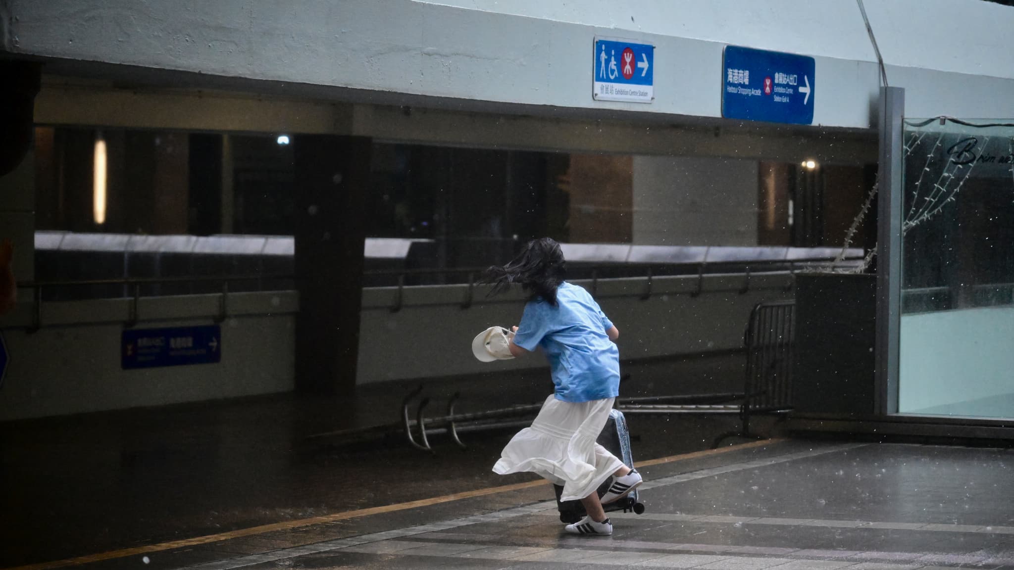A person crosses a bridge in Hong Kong on July 20, 2025.
