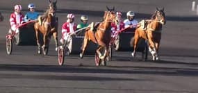 Christophe Delay, casaque rouge et blanche, dispute le Prix d'Amérique