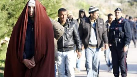 Des immigrants illégaux tunisiens encadrés par la police italienne à leur arrivée sur l'île de Lampedusa. La surveillance de la frontière franco-italienne a été renforcée pour faire face à l'éventuelle arrivée en France de réfugiés tunisiens venus d'Itali