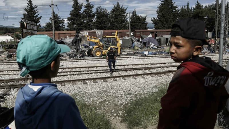 Deux enfants voient se dérouler devant leurs yeux l'opération de police visant à évacuer le camp d'Idomenie, le 25 mai 2016.