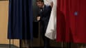 Le président Emmanuel Macron sort de l'isoloir après avoir voté au second tour des législatives le 19 juin 2022 au Touquet