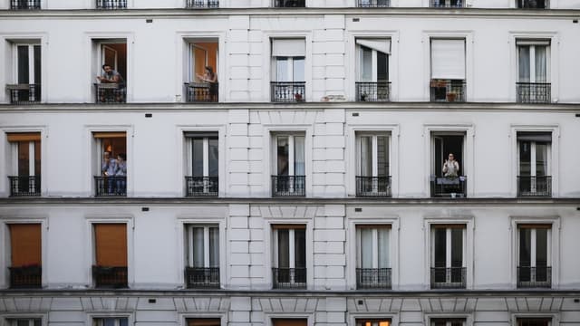 Des Français à leurs fenêtres pour applaudir les soignants en première ligne dans la lutte contre le Covid-19, le 30 mars 2020.