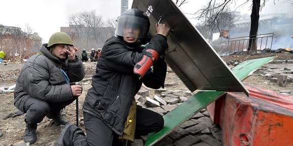 Des manifestants se protègent des tirs d’un sniper, à Kiev, jeudi. Des manifestants se protègent des tirs d’un sniper, à Kiev, jeudi.
