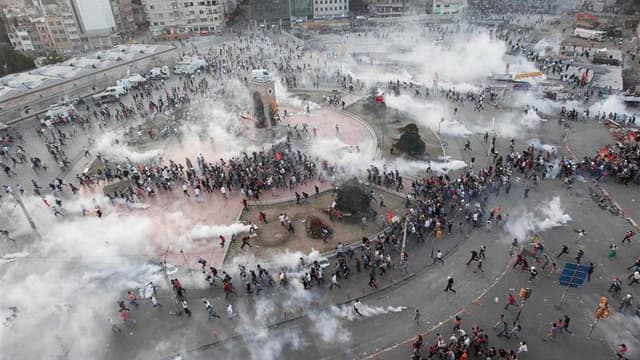 En tirant des grenades lacrymogènes et en utilisant des canons à eau, la police turque a repoussé mardi soir des milliers de manifestants qui tentaient de réinvestir la place Taksim, à Istanbul. /Photo prise le 11 juin 2013/REUTERS/Osman Orsal