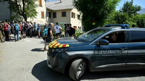 Un véhicule de la gendarmerie passe près de bénévoles participant aux recherches d'Emile, deux ans et demi, disparu samedi dernier, le 10 juillet 2023 au Vernet, dans les Alpes-de-Haute-Provence