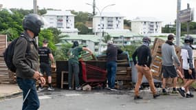 Des habitants masqués de quartiers situés au sud de la capitale dressent des barrages pour bloquer l'accès et canaliser les militants indépendantistes à l'entrée de Tuband, dans le quartier de Motor Pool à Nouméa, le 15 mai 2024.