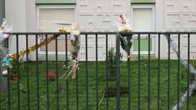 Des bouquets de fleurs sur la clôture juste devant l'appartement du rez-de-chaussée où les corps d'une femme et de ses quatre enfants ont été découverts, à Meaux, dans l'est de Paris.