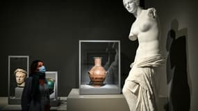 Une femme regarde "La Venus de Milo" durant une visite de presse de l'exposition "Paris-Athènes. Naissance de la Grèce moderne 1675-1919" au Louvre à Paris le 24 septembre 2021