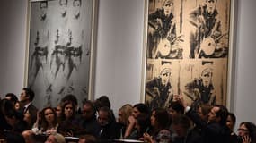 "Triple Elvis" et "Four Marlon", deux toiles signés Andy Warhol et qui se sont envolées lors d'une vente aux enchères chez Christie's, le 12 novembre 2014.