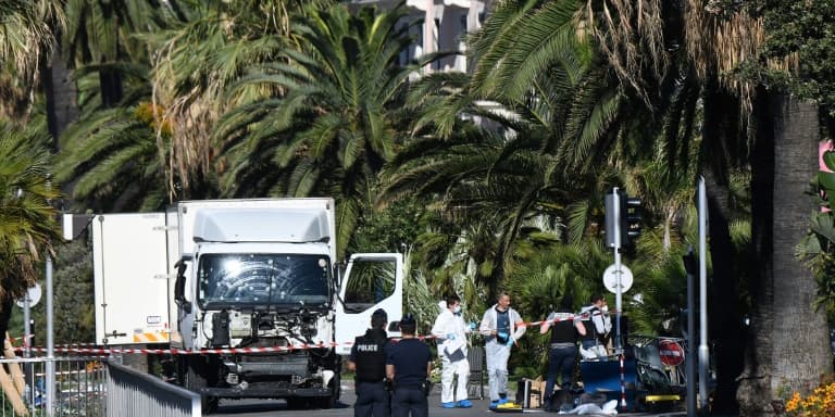 Des policiers et des experts légistes devant le camion qui a foncé sur le foule rassemblée le soir du 14 juillet sur la promenade des Anglais, au lendemain de l'attentat, le 15 juillet 2016 à Nice