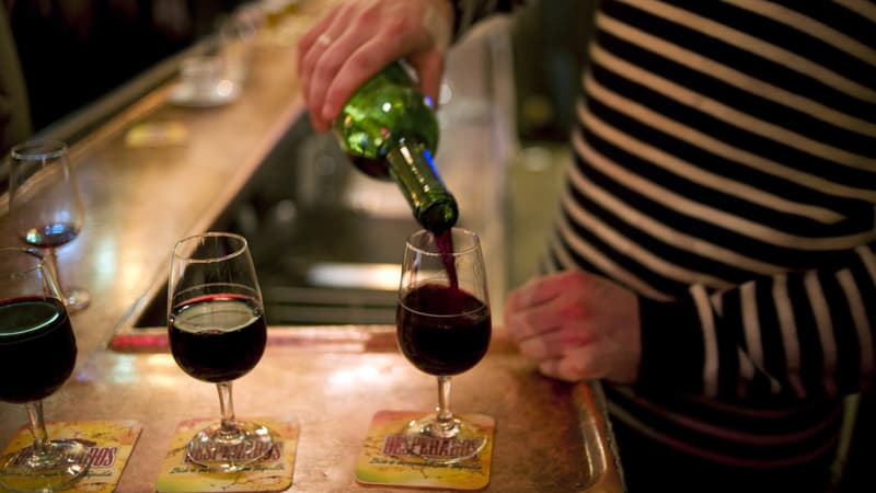 Un serveur verse du vin dans des verres dans un bar à Paris, en 2011 (photo d'illustration)