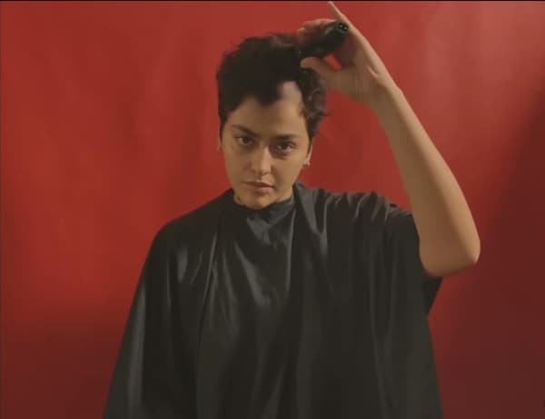Iranian Reyhane Parsaj shaves her head in protest at the death of Mahsa Amini.