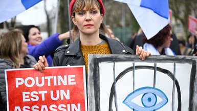 Des électeurs font la queue devant l'ambassade russe à Paris, dont de nombreux avec des pancartes anti-Poutine, le dernier jour de l'élection présidentielle, le 17 mars 2024