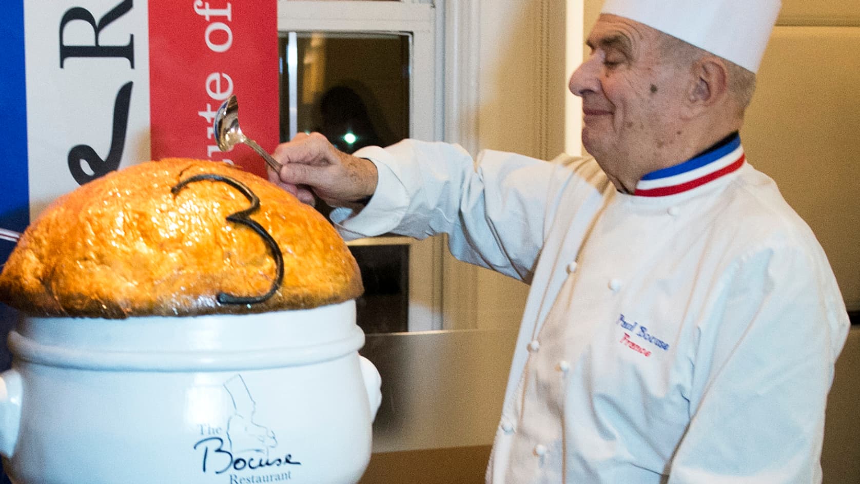 Paul Bocuse "casse la croûte" d'une version géante de sa soupe VGE en 2013.