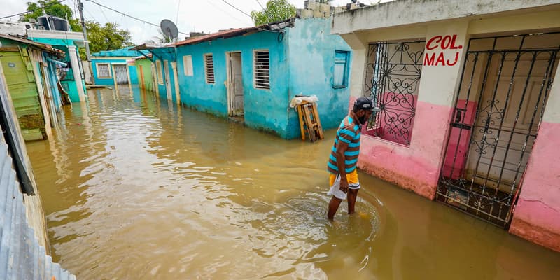 Un homme marche le long d'une rue inondée avant l'arrivée de l'ouragan Melissa dans le quartier de Las Cucarachas à Saint-Domingue, en République dominicaine, le 28 octobre 2025. (Photo d'illustration). 