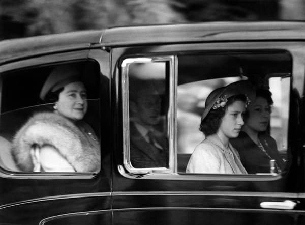 Princess Elizabeth of York (R), Princess Margaret (2nd R, front), their parents Queen Elizabeth Bowes-Lyon (L) and King George VI (2ndL), arrive at Balmoral, on August 27, 1945 for their holidays in Scotland.