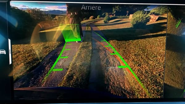 L’aide à la marche arrière se base sur les 50 derniers mètres enregistrés à moins de 30km/h. Les lignes vertes matérialisent ce trajet à reproduire, alors que les caméras signalent les obstacles par des carrés. La seconde partie de l’écran montre le véhicule en 3D vue de haut. 