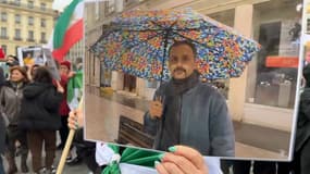 Une manifestante brandit un portrait de Mohammad Moradi.