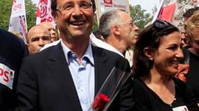 François Hollande dans le défilé du 1er-Mai, dimanche, à Paris. L'ancien premier secrétaire du Parti socialiste affirme qu'il a l'intention d'aller jusqu'au bout de la primaire socialiste pour la présidentielle, mais aussi, a-t-il souligné, du scrutin de