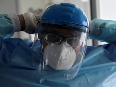 Un membre du personnel soignant de l'hôpital El Tunal à Bogota en Colombie se prépare avant de s'occuper d'un patient atteint du Covid-19