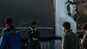 La gendarmerie face à plusieurs migrants sur l'A16 près de Calais, après qu'ils aient tenté de monter à bord de camions le 21 janvier 2016.