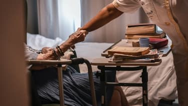 Image d'illustration - Une personne âgée tenant le bras d'une aide-soignante dans un établissement EHPAD parisien