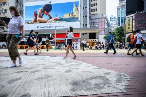 Des habitants de Hong Kong foulent le 2 juin 2020 un trottoir dont les pavés ont été remplacés par du béton par les autorités locales, en réponse aux manifestations pro-démocratie. Des habitants de Hong Kong foulent le 2 juin 2020 un trottoir dont les pavés ont été remplacés par du béton par les autorités locales, en réponse aux manifestations pro-démocratie.