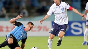 Japanese footballer Kazuyoshi Miura (right) says he wants to continue playing at the age of 54