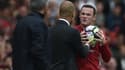 Pep Guardiola et Wayne Rooney lors du derby de Manchester
