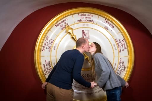 Des visiteurs de l'exposition de "l'Epicentre de l'amour" à Banska Stiavnica s'embrassent devant "l'amouromètre", censé tester la force de leur amour, le 3 février 2018