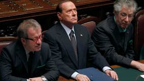 Silvio Berlusconi (ici entre le ministre de la Justice Roberto Maroni, à droite et le chef de file de la Ligue du Nord Umberto Bossi) a obtenu mardi la ratification par la chambre basse du parlement italien des comptes publics 2010 mais le résultat du vot