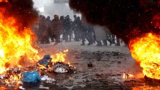 Un rideau de flammes sépare manifestants et policiers, jeudi, à Kiev.
