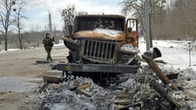 Un soldat près d'un lance-roquettes multiple russe détruit, le 16 mars aux abords de Kharkiv, en Ukraine
