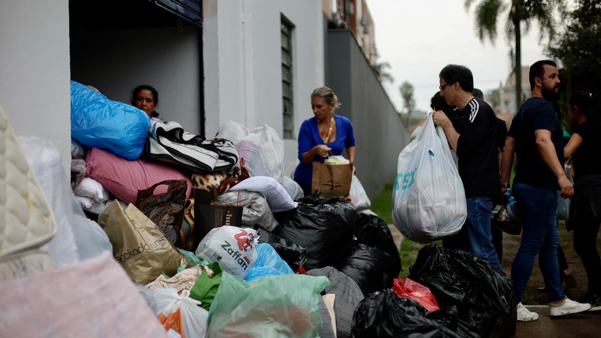 Des personnes font don de vêtements et de nourriture aux sinistrés des inondations dans un gymnase de l'État à Porto Alegre, dans l'État du Rio Grande do Sul, au Brésil, le 4 mai 2024. 
