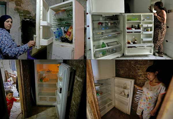 Des libanais posent devant des frigo vides pour les photographes de l'AFP Des libanais posent devant des frigo vides pour les photographes de l'AFP