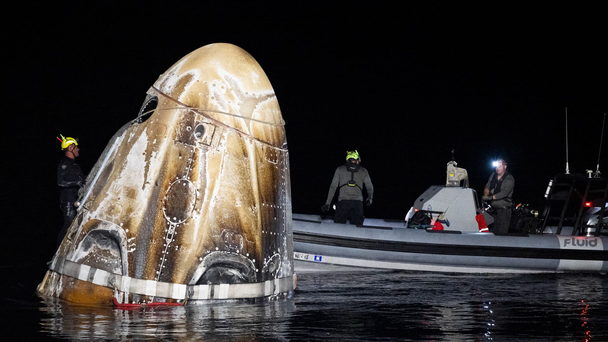 Support crews work around the SpaceX Dragon Endeavor spacecraft shortly after it touched down with NASA astronauts Matthew Dominick, Michael Barratt, and Janet Epps, and Roscosmos astronaut Alexander Grebenkin aboard, in the Gulf of Mexico off the coast of Pensacola, Florida, October 25, 2024.